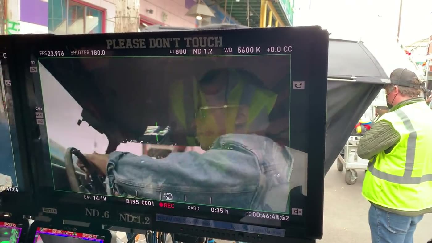 Director's monitor showing a live car-interior shot mid-take